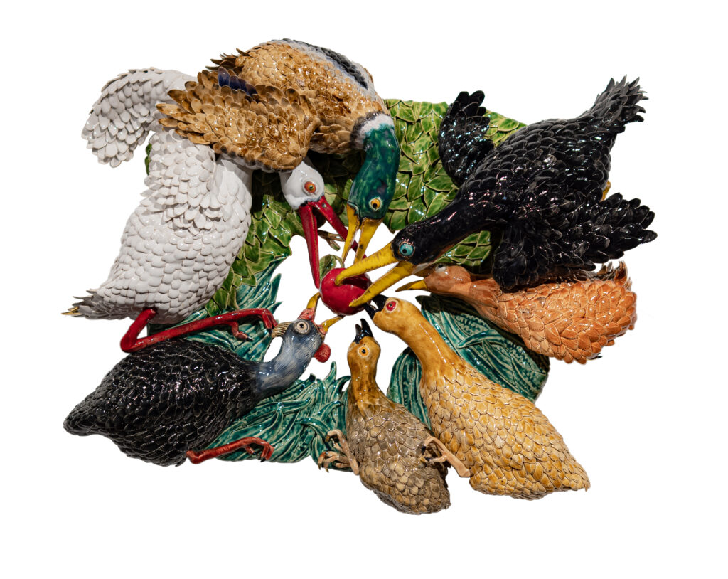 Glazed ceramic birds with long beaks crowded together around a single red berry, from Onno Theelen's Strange Creatures