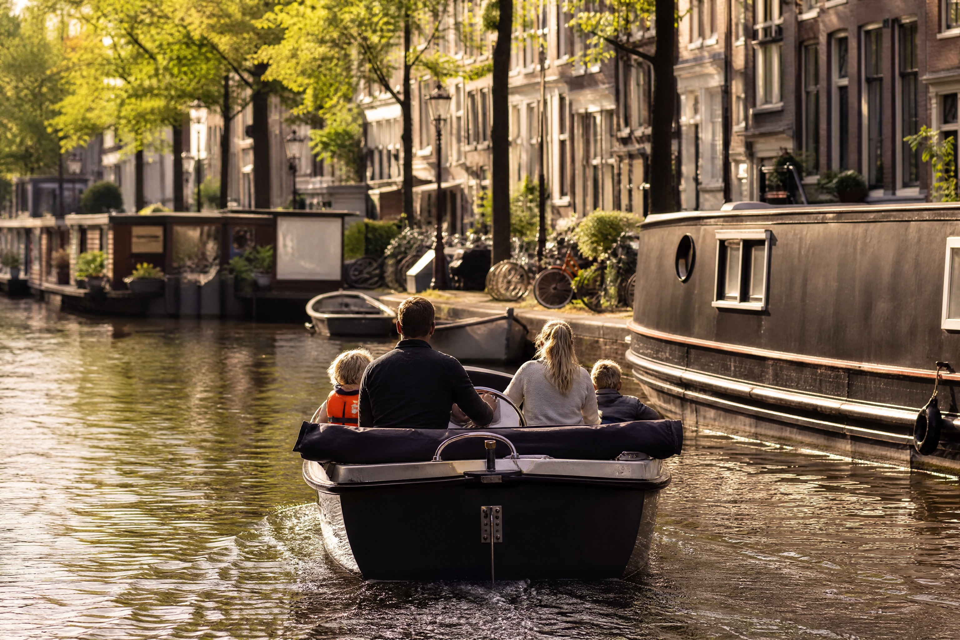 Family on a self-drive electric boat on an Amsterdam canal