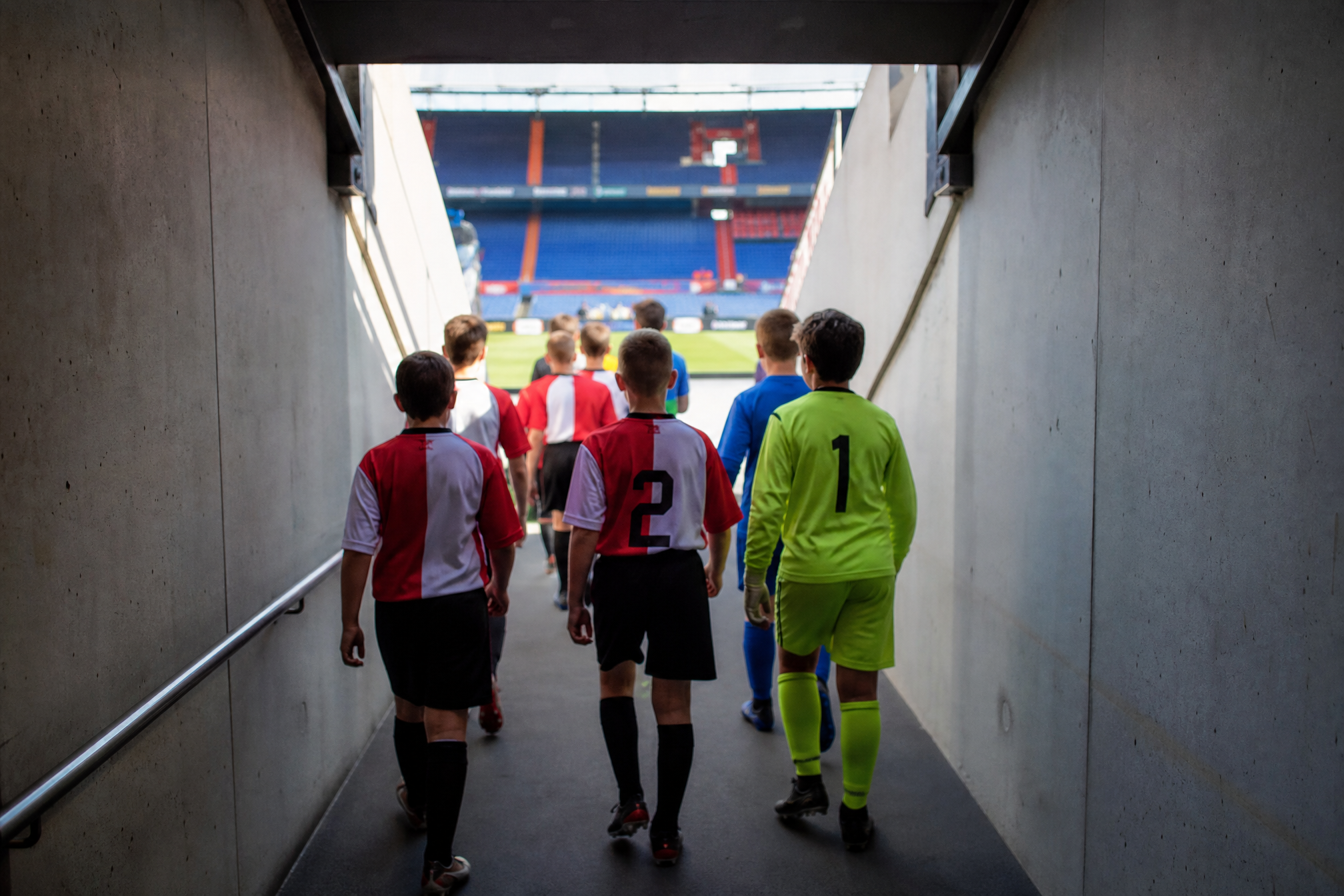 Kids walking through a stadium players tunnel for a football birthday party