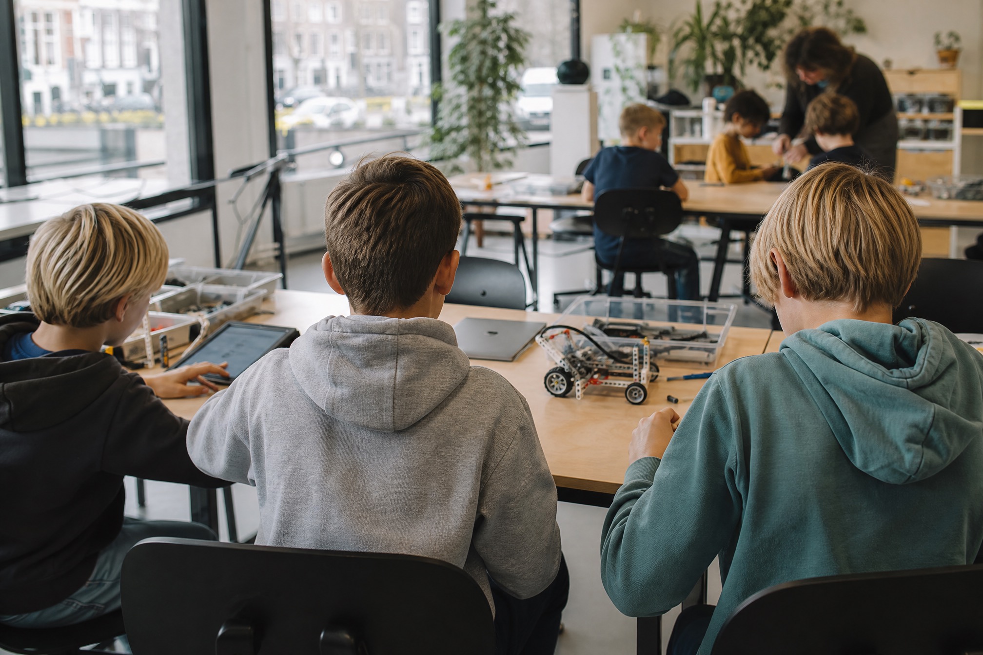Kids building and programming a LEGO robot at a robotics birthday party in Amsterdam
