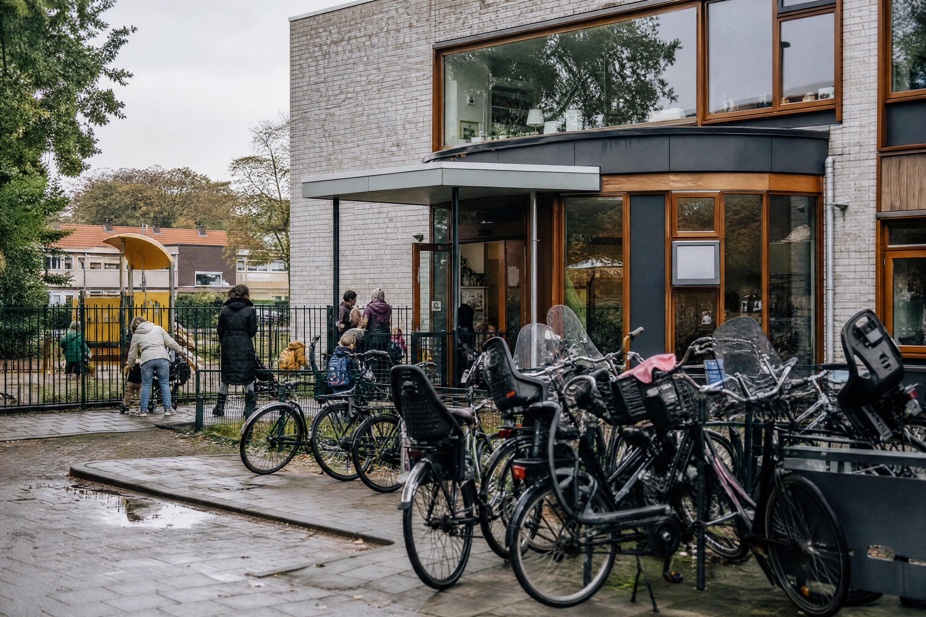 Bicycles with child seats parked outside a Dutch daycare at pickup time