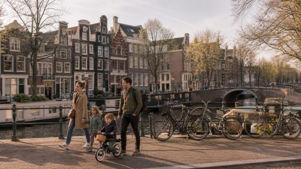 A family with young children beside a canal in Amsterdam, the Netherlands