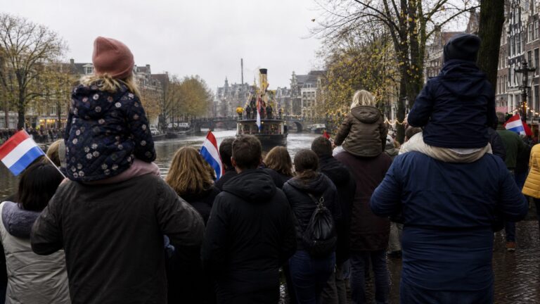 Sinterklaas for expat families watching the Amsterdam arrival parade along a canal
