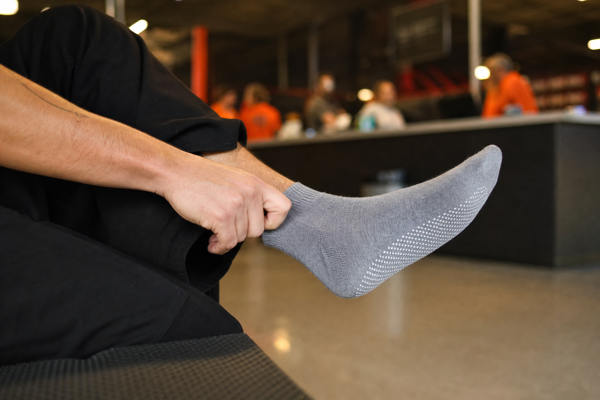 Putting on grip socks before jumping at a Dutch trampoline park