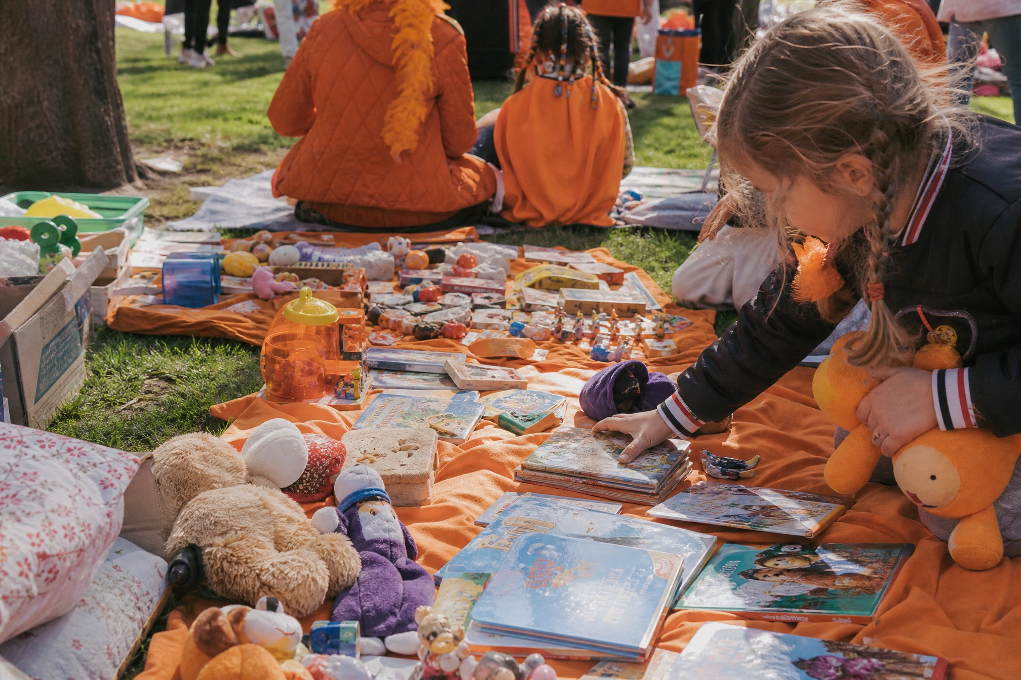 Childrens flea market blanket with secondhand toys and books for Kings Day 2027