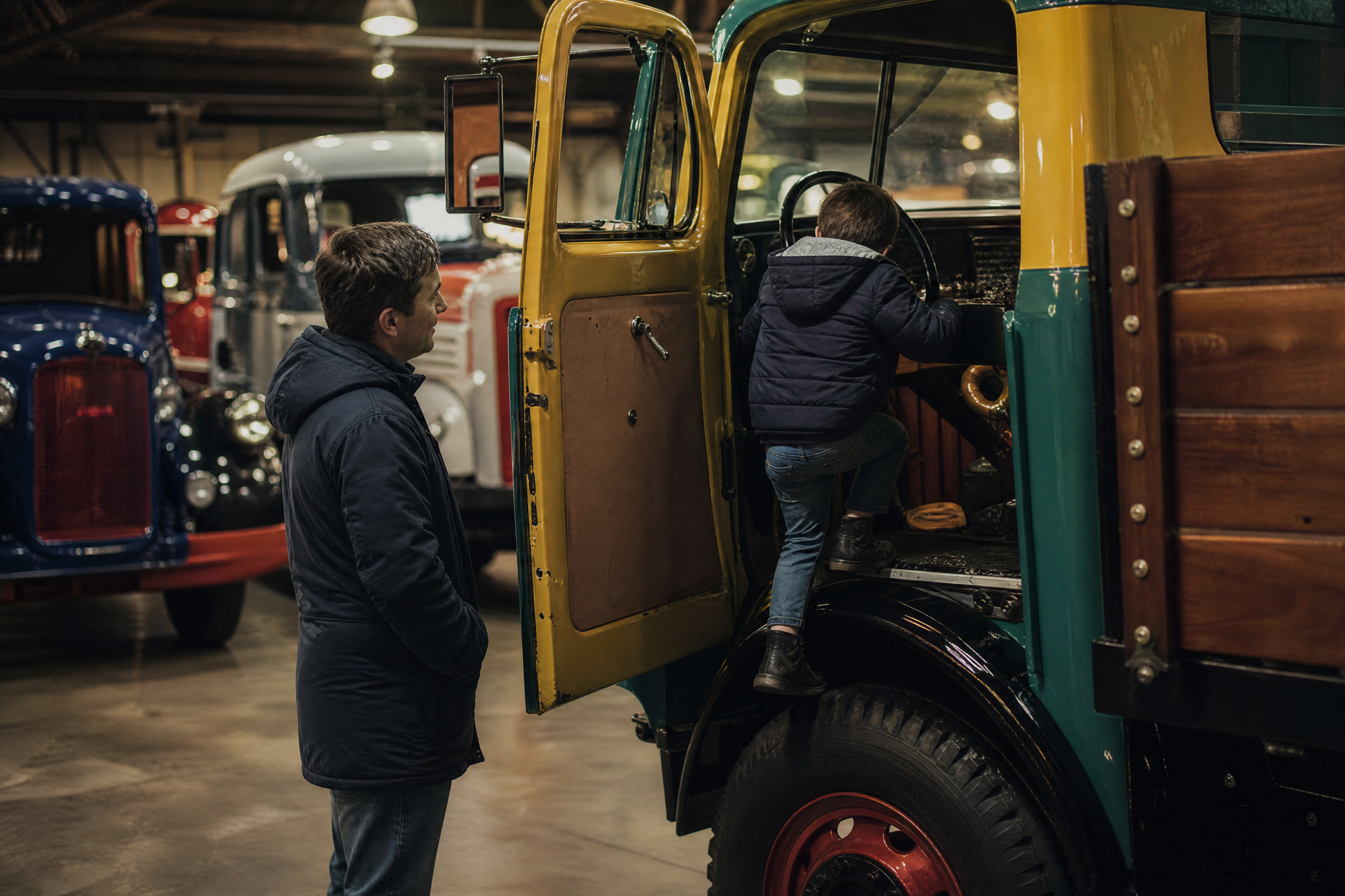 Child climbing into a vintage truck cab at the DAF Museum in Eindhoven with kids