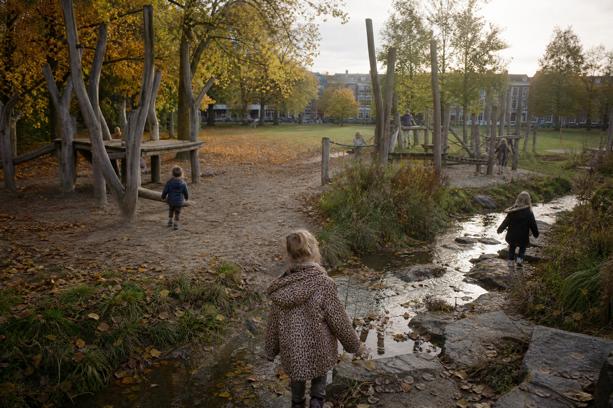 Kids playing in nature playground in a park in The Hague in autumn